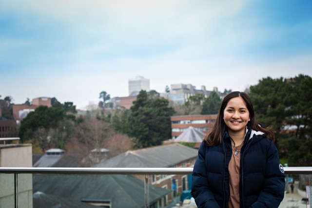 INTO University of Exeter biosciences pathway student Sarah from Singapore poses on campus.