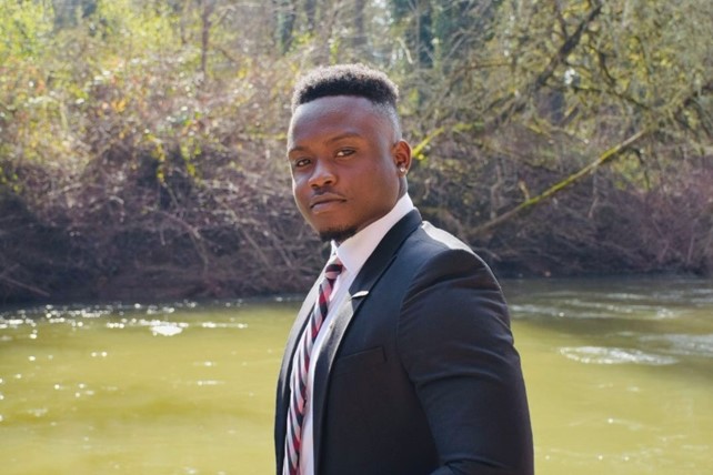 Oregon State University and INTO OSU alumnus Godson from Nigeria poses outdoors.