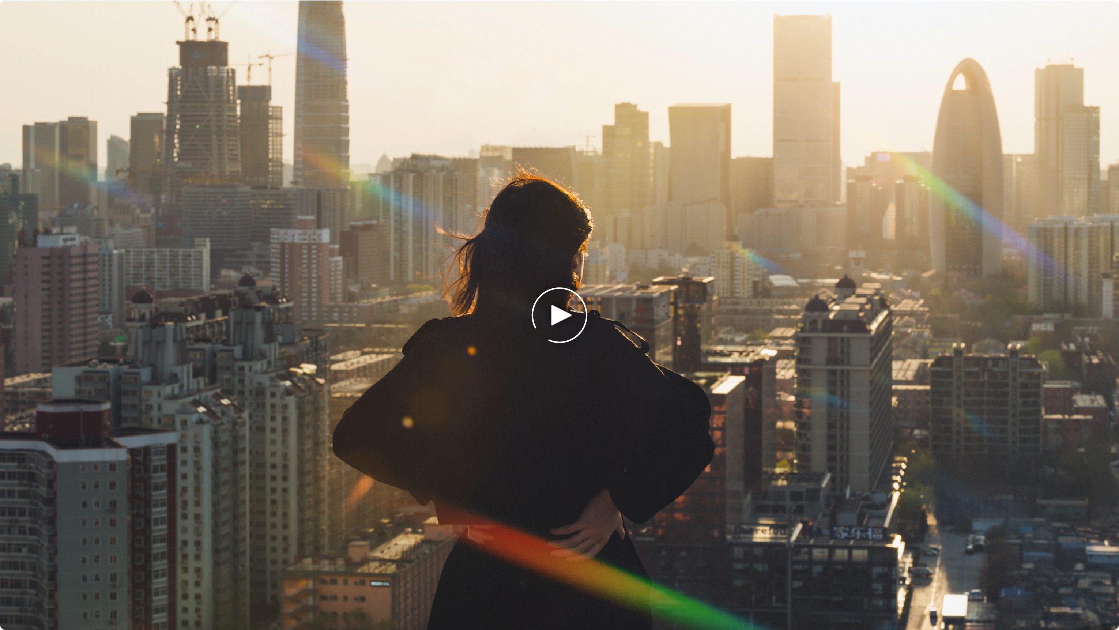 Woman on top of a building looking out over the city