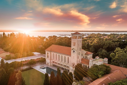 Aerial view of The University of Western Australia’s Hackett Hall at sunrise, overlooking Matilda Bay.