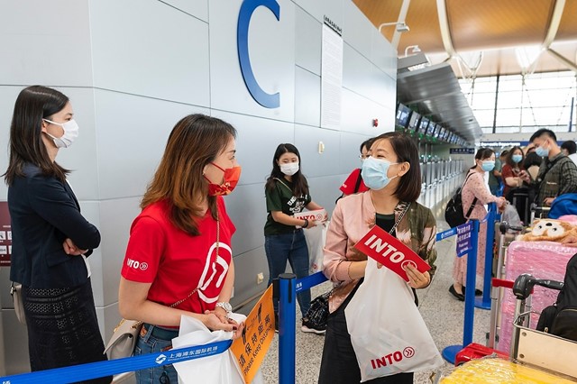 International student consults INTO team member before boarding charter flight from China to UK.